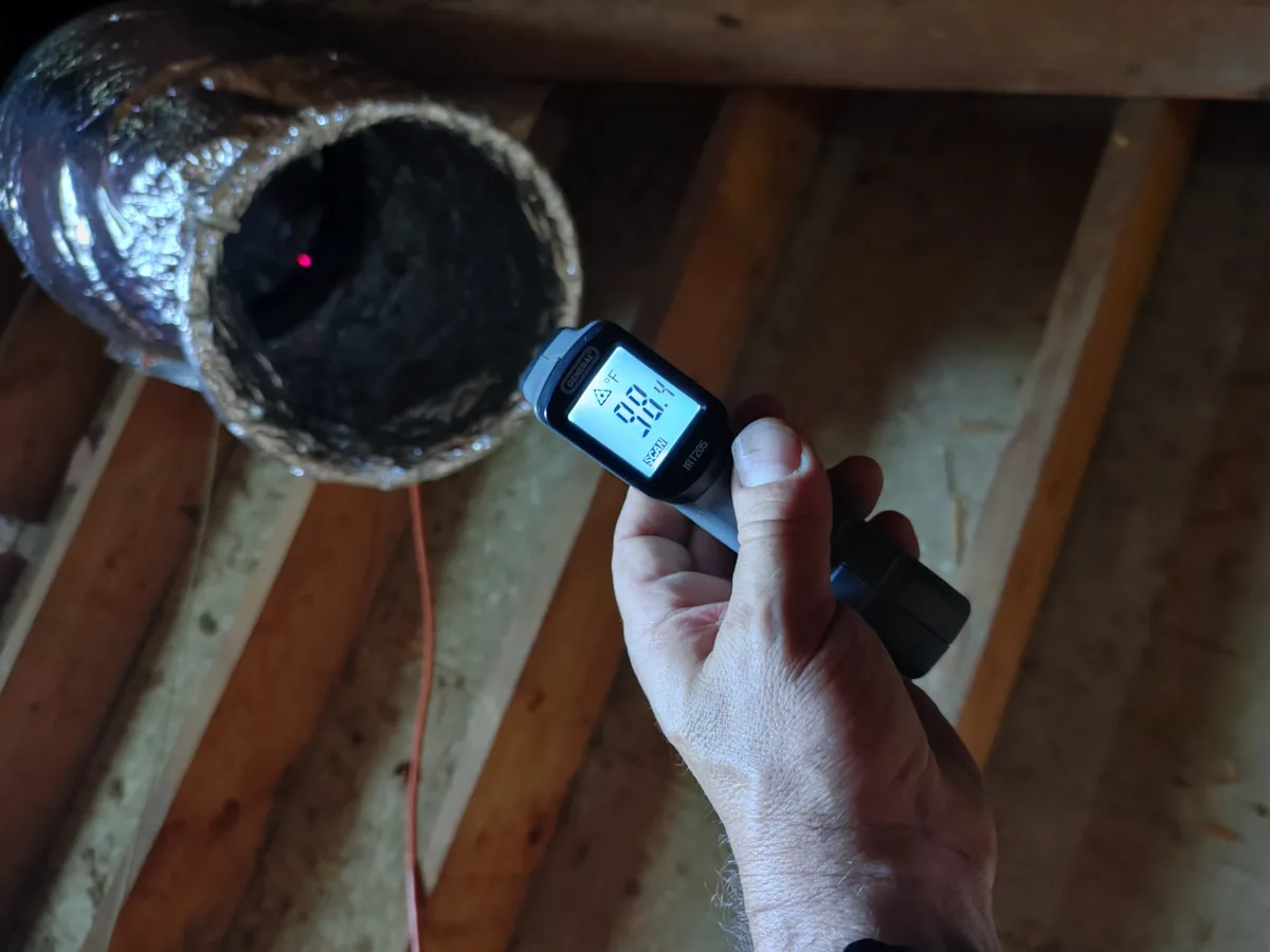 Infrared thermometer reading 98.4 degrees on the air coming out of an Attic Torpedo flex duct in an attic